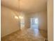 Open dining area with chandelier lighting and tile flooring, ready for personalization at 4381 Sw 90Th Pl, Ocala, FL 34476