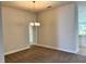 Cozy dining area featuring a chandelier and seamless transition to the kitchen at 4381 Sw 90Th Pl, Ocala, FL 34476