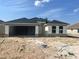 New construction home featuring a modern design with a two-car garage and neutral color palette at 4381 Sw 90Th Pl, Ocala, FL 34476
