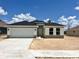 New single-Gathering home featuring a two-car garage, neutral paint scheme, and a well-manicured lawn at 4381 Sw 90Th Pl, Ocala, FL 34476