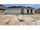 New home with a two-car garage, modern design, and bright windows awaiting landscaping at 4381 Sw 90Th Pl, Ocala, FL 34476
