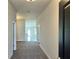 Inviting hallway featuring neutral paint, carpet and views of the home's open layout at 4381 Sw 90Th Pl, Ocala, FL 34476