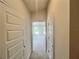 Hallway with neutral walls connecting rooms, creating a cohesive flow throughout the house at 4381 Sw 90Th Pl, Ocala, FL 34476