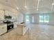 Modern kitchen features white cabinetry, stainless steel appliances, and a granite island at 4381 Sw 90Th Pl, Ocala, FL 34476