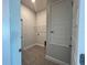 Convenient laundry room boasts tiled floors, shelving, and a door for storage at 4381 Sw 90Th Pl, Ocala, FL 34476