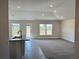 Inviting living area with tile flooring, natural light, and a view of the kitchen at 4381 Sw 90Th Pl, Ocala, FL 34476