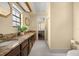 Bathroom featuring double sinks, granite countertops, and tiled floors at 4425 Se 2Nd Pl, Ocala, FL 34471