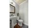 Bathroom features a pedestal sink, toilet, and tiled floors at 4425 Se 2Nd Pl, Ocala, FL 34471