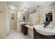 Well-lit bathroom featuring double sinks, large mirror and an over-the-sink vanity at 4425 Se 2Nd Pl, Ocala, FL 34471