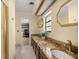 Bathroom featuring double sinks, granite countertops, and tiled floors at 4425 Se 2Nd Pl, Ocala, FL 34471