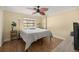 Bedroom with wood floors, ceiling fan and a large window offering plenty of light at 4425 Se 2Nd Pl, Ocala, FL 34471