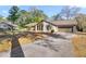 Inviting home showcasing a stone accent wall, attached garage, and well-maintained driveway at 4425 Se 2Nd Pl, Ocala, FL 34471