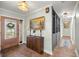 Inviting foyer with tile flooring, a wooden cabinet, and a beautifully decorated front door at 4425 Se 2Nd Pl, Ocala, FL 34471