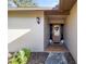 Welcoming front entrance with a decorative door, stylish lighting, and neatly landscaped surroundings at 4425 Se 2Nd Pl, Ocala, FL 34471