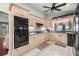 Well-equipped kitchen with modern appliances, light wooden cabinets, and tile flooring at 4425 Se 2Nd Pl, Ocala, FL 34471