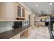 Bright kitchen features light wood cabinetry, modern appliances, breakfast bar, and a convenient built-in workspace at 4425 Se 2Nd Pl, Ocala, FL 34471