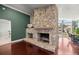 Close-up on the living room's stone fireplace with views to the outdoor spaces at 4425 Se 2Nd Pl, Ocala, FL 34471