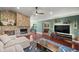 Cozy living room featuring a stone fireplace, hardwood floors, and stylish decor at 4425 Se 2Nd Pl, Ocala, FL 34471