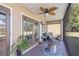Relaxing screened patio with stylish furniture and ceiling fan, perfect for enjoying the outdoors at 4425 Se 2Nd Pl, Ocala, FL 34471