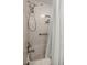 Shower featuring adjustable shower head, built-in shelves, and a safety bar at 4425 Se 2Nd Pl, Ocala, FL 34471