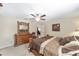 Bright main bedroom boasts a ceiling fan, dresser, and comfortable furnishings at 4826 Sw Dahlia Ct, Dunnellon, FL 34431