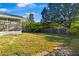 Green grass and a screened patio perfect for entertaining are highlights of this backyard at 53 Juniper Trail Cir, Ocala, FL 34480