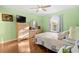 Bedroom with hardwood flooring, spacious layout, and TV at 53 Juniper Trail Cir, Ocala, FL 34480