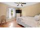 Bright bedroom boasts a large window, neutral colors, and ceiling fan at 53 Juniper Trail Cir, Ocala, FL 34480