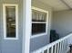 Charming covered front porch with seating area; a welcoming entry point to this home at 53 Juniper Trail Cir, Ocala, FL 34480