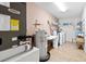 Functional laundry room featuring washer, dryer, and ample shelving at 53 Juniper Trail Cir, Ocala, FL 34480