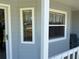 Cozy, covered front porch featuring updated windows and neutral paint at 53 Juniper Trail Cir, Ocala, FL 34480