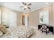 Tranquil bedroom with neutral walls, plantation shutters, ceiling fan, and a black desk for a comfortable retreat at 5331 Nw 35Th Lane Rd, Ocala, FL 34482