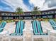 Community clubhouse featuring Adirondack chairs with striped cushions and landscaping at 5331 Nw 35Th Lane Rd, Ocala, FL 34482