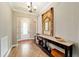 Elegant foyer with wood-look tile flooring and a decorative console table at 5331 Nw 35Th Lane Rd, Ocala, FL 34482