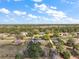 Aerial view of a property with mature trees and a pond at 5926 Ne 62Nd Court Rd, Silver Springs, FL 34488