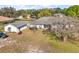 Backyard view of home with a detached garage and screen porch at 5926 Ne 62Nd Court Rd, Silver Springs, FL 34488
