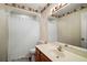 Traditional bathroom featuring a vanity, toilet, and shower with charming wallpaper border at 5926 Ne 62Nd Court Rd, Silver Springs, FL 34488