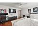 Spacious bedroom with wood floors, a ceiling fan, and custom wall decor at 5926 Ne 62Nd Court Rd, Silver Springs, FL 34488