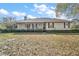 Inviting single-story home with a covered porch and well-kept landscaping at 5926 Ne 62Nd Court Rd, Silver Springs, FL 34488