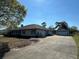 Charming single-story home with a long driveway and a detached two-car garage under a bright blue sky at 5926 Ne 62Nd Court Rd, Silver Springs, FL 34488