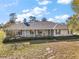 Charming single-story home with a covered front porch and manicured landscaping at 5926 Ne 62Nd Court Rd, Silver Springs, FL 34488