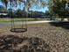 Front yard with a swing and mature trees at 5926 Ne 62Nd Court Rd, Silver Springs, FL 34488