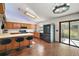 Well-lit kitchen features brick flooring, modern stainless-steel appliances, and an eat-in bar at 5926 Ne 62Nd Court Rd, Silver Springs, FL 34488