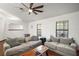 Spacious living room with hardwood floors, dual sofas, and bright windows at 5926 Ne 62Nd Court Rd, Silver Springs, FL 34488