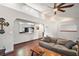 Cozy living room with hardwood floors, a rustic coffee table, and a view into the kitchen at 5926 Ne 62Nd Court Rd, Silver Springs, FL 34488