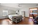 Bright main bedroom featuring hardwood floors, a ceiling fan, and access to the bathroom at 5926 Ne 62Nd Court Rd, Silver Springs, FL 34488