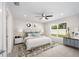 Comfortable bedroom with a ceiling fan and natural light from the backyard view at 6620 Se 108Th Ln, Belleview, FL 34420