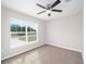 Bedroom with a ceiling fan and a backyard view at 6620 Se 108Th Ln, Belleview, FL 34420