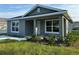 Quaint home with a welcoming front porch and freshly landscaped garden at 6620 Se 108Th Ln, Belleview, FL 34420