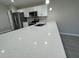 Close-up view of a kitchen with a white quartz countertop and stainless steel appliances at 6620 Se 108Th Ln, Belleview, FL 34420